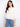 Chic white blouse showcasing delicate eyelet detailing and a stylish scalloped hem for a feminine touch by Charlie B.