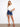 Button closure on the jacket complements the simple elegance of the rolled hem denim shorts by Charlie B.