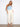 Regular rise natural twill pants styled with sleek sandals and a light blue top, offering everyday elegance. Designed by Charlie B.