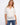 Stylish white crochet top with a chic notch neckline and placket detail, perfect for casual outings by Charlie B.