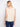 This white sleeveless top has a loose fit with charming scalloped edges, ideal for any occasion by Charlie B.