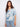 Floral blouse with a chic Henley neckline and soft blue pattern, perfect for casual outings. Crafted with care by Charlie B.